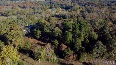 Aerial view of property's location with a forest