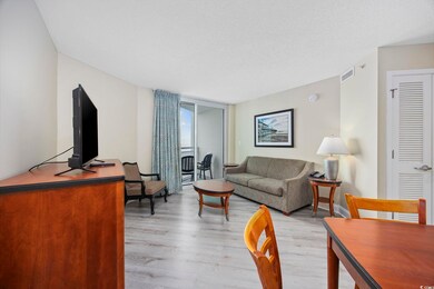 Living room with a textured ceiling, floor to ceil