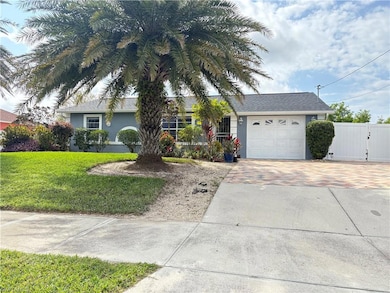 Single story home featuring a garage, fence, decor