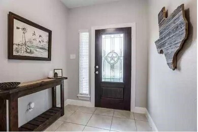 Doorway to property featuring stone siding, brick 