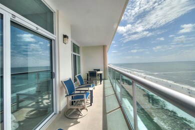 Balcony with view of water and beach