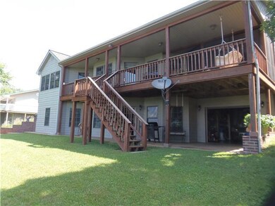 Rear covered deck and walkout basement with game room, bunk room and shop area. There is also a storm shelter