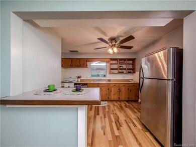 Spacious kitchen has great flow, newer hardwoods, and breakfast bar.