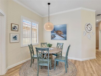Dining area featuring wood finished floors, crown 