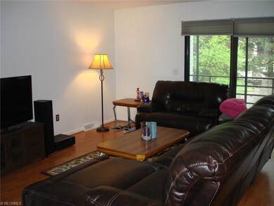 Spacious livingroom with laminate wood floors, whi