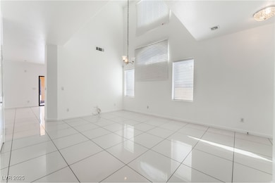 Spare room featuring a high ceiling, visible vents