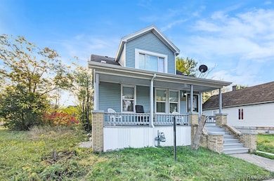 Bungalow featuring covered porch and stairway