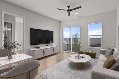 Living area with ceiling fan, light wood-style fl