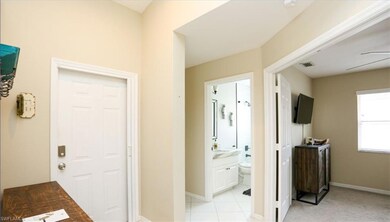 Corridor featuring light tile patterned floors