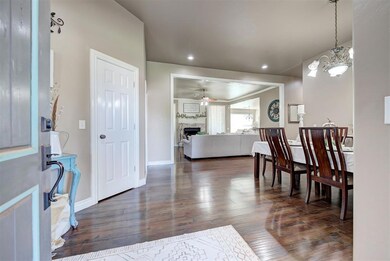Dining space with ceiling fan with notable chandel