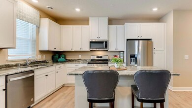 This functional kitchen boasts 42' cabinets with hardware, stainless steel appliances and granite countertops. Image is of model, colors may vary.