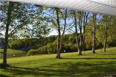 A long row of towering, mature trees line the front of the home offering an umbrella of shade in the summertime to the serene area. Relax on the Covered Porch extending the full length of home while enjoying the panoramic countryside views.
