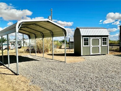 Covered parking, and shed with a loft.