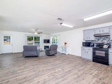 Kitchen with black appliances, ceiling fan, decora