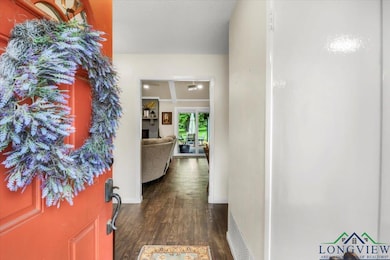 Entryway with dark wood-style floors and baseboards