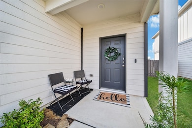 Covered front entry with upgraded front door and welcoming charm.