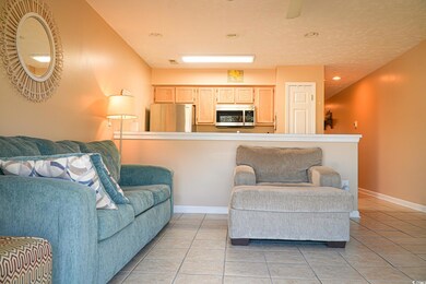 Living area featuring light tile patterned floors,