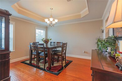 Beautiful dining room with a step up ceiling and c