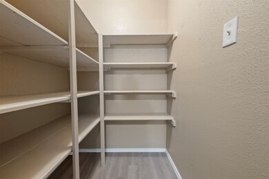 This photo shows a small pantry or storage room wi