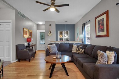 Living room with bamboo floors, that flows from the entryway and basement stairs.
