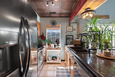 Kitchen featuring light tile patterned floors, dar
