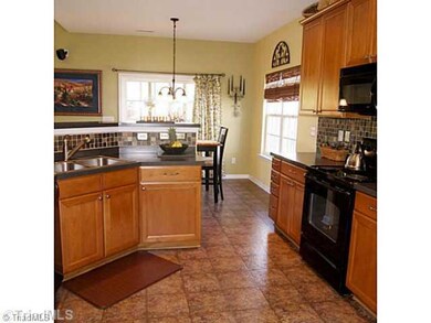 Kitchen. Bright Kitchen with Large Cabinets and Tile Backsplash