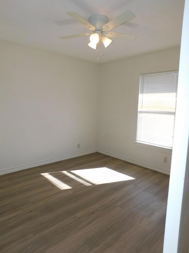 Unfurnished room with dark wood-style flooring, c