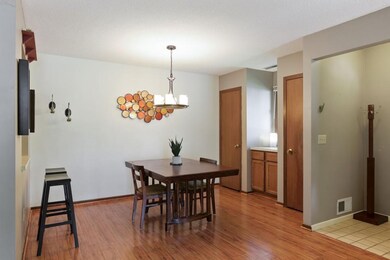 Dining Room has beautiful flooring, updated lighti