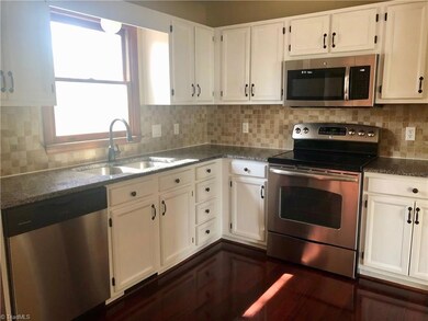 Spacious and bright Kitchen with granite counter tops and tiles back splash.