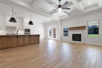 Unfurnished living room with beamed ceiling, light