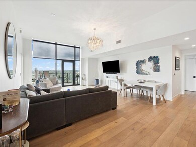 Living room with a chandelier, light wood finishe