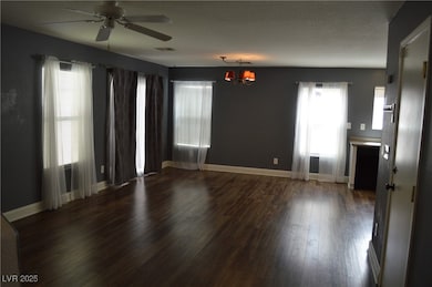 Unfurnished room featuring a ceiling fan, wood fin