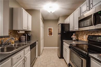 White kitchen cabinets, updated back splash, pantr