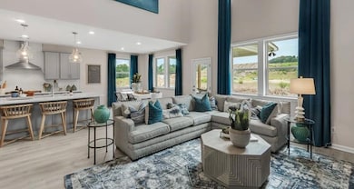 Living area with light wood-style flooring and recessed lighting