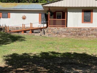 Front entrance with ramp and steps to covered fron