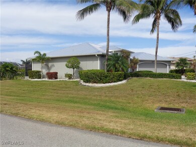 View of side of property featuring a lawn, metal r