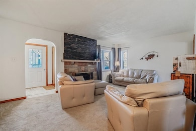 Cozy living room with soft carpeting, a striking s