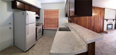 A roomy galley style kitchen features pl