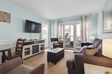 Living area featuring crown molding and wainscoting