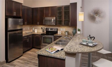 Kitchen featuring decorative backsplash, stainless steel appliances, light hardwood / wood-style floors, and sink