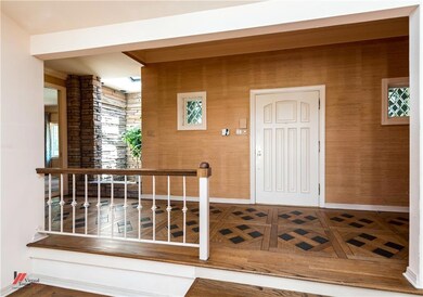 Entry with inlaid wood flooring, grass wall paper 