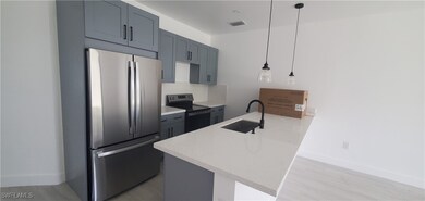 Kitchen featuring visible vents, decorative light