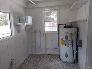 Large utility room 7 x 11 with new flooring, plenty of storage and it is heated