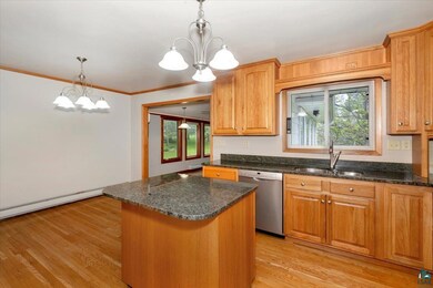 Kitchen featuring dishwasher, sink, light wood-typ