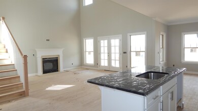 View from Kitchen Island looking into Great room.  Pics are from a previously built home 