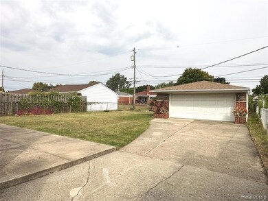 View of yard featuring a detached garage and an outdoor structure