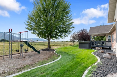 View of yard featuring a playground and a deck with mountain view