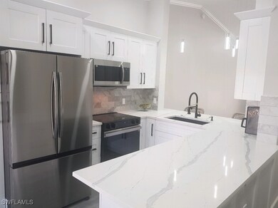 Kitchen featuring kitchen peninsula, light stone c