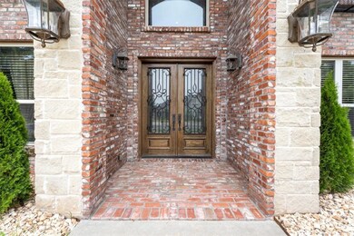 2 story brick entrance flanked with large white st