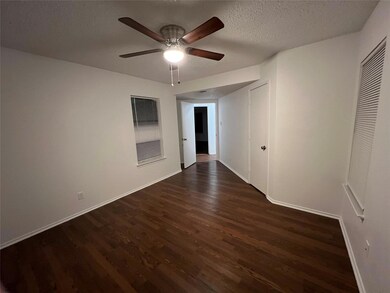 Unfurnished room with ceiling fan, dark hardwood /